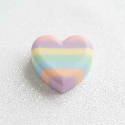 Heart-shaped soap in natural colours on the sparkling background