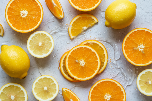 Hyaluronic Acid & Vitamin C cover image with lemons, water, and oranges