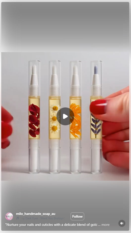 Set of four bottles with visible ingredients, held by a hand.