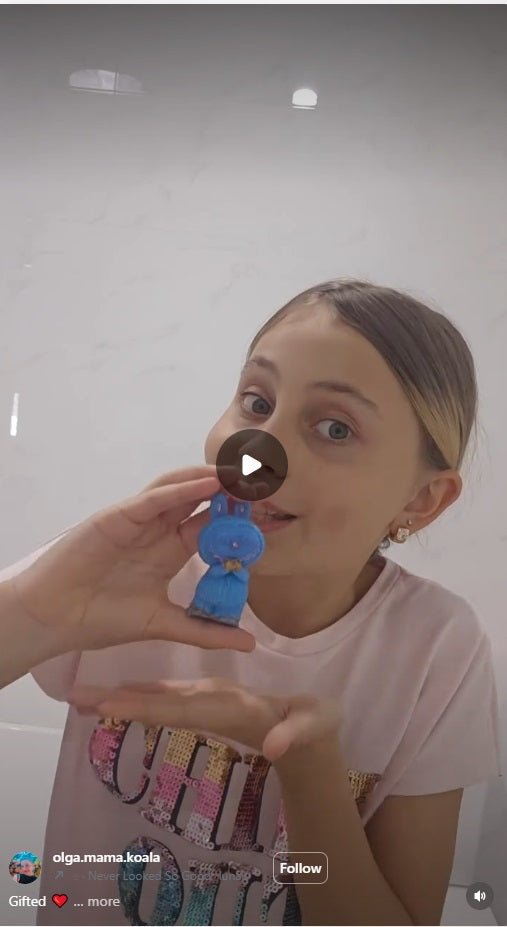 Child holding a blue toy soap with a white background